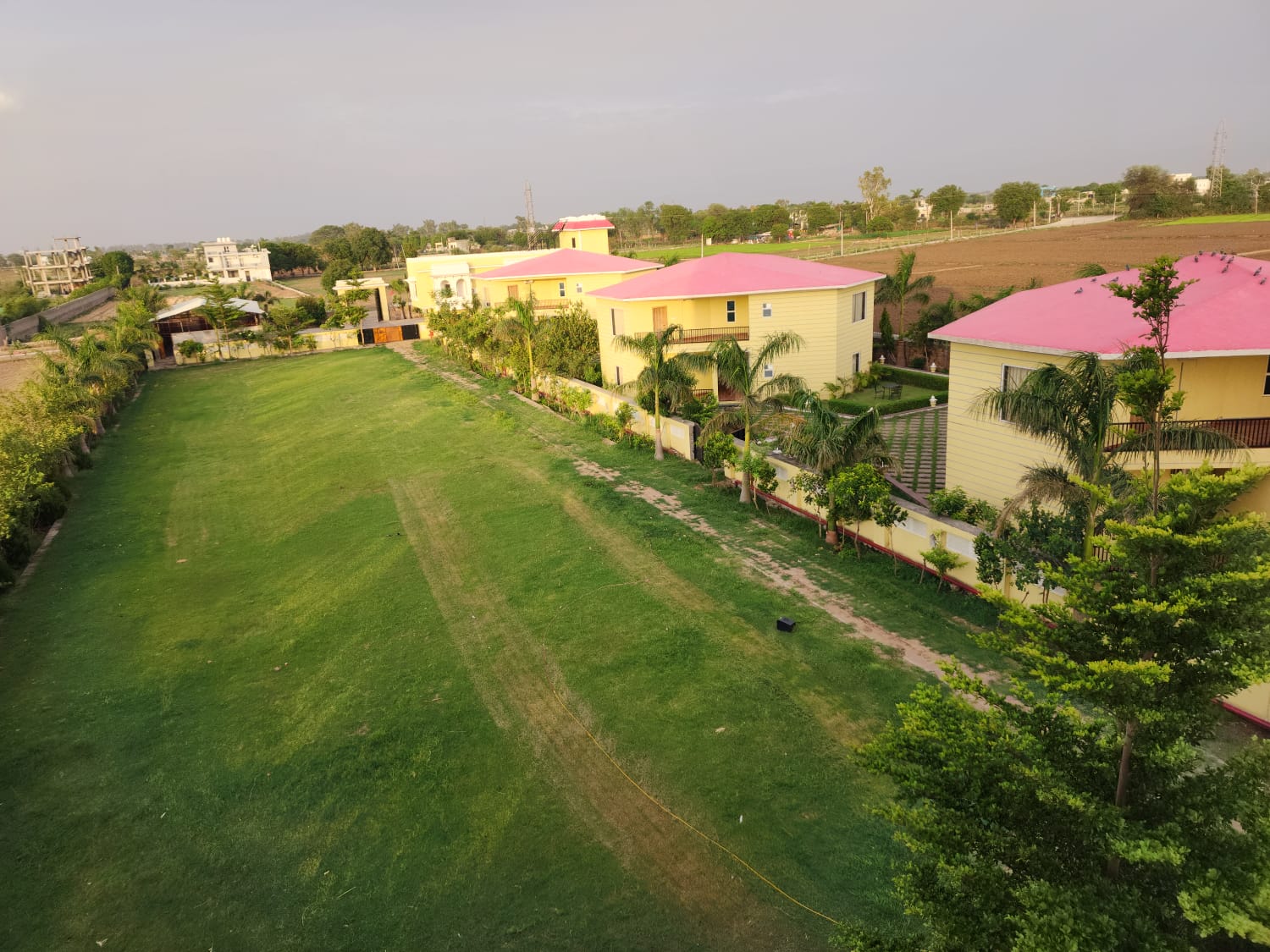 Grand lawns and cottages of The Pearl Resort Kota
